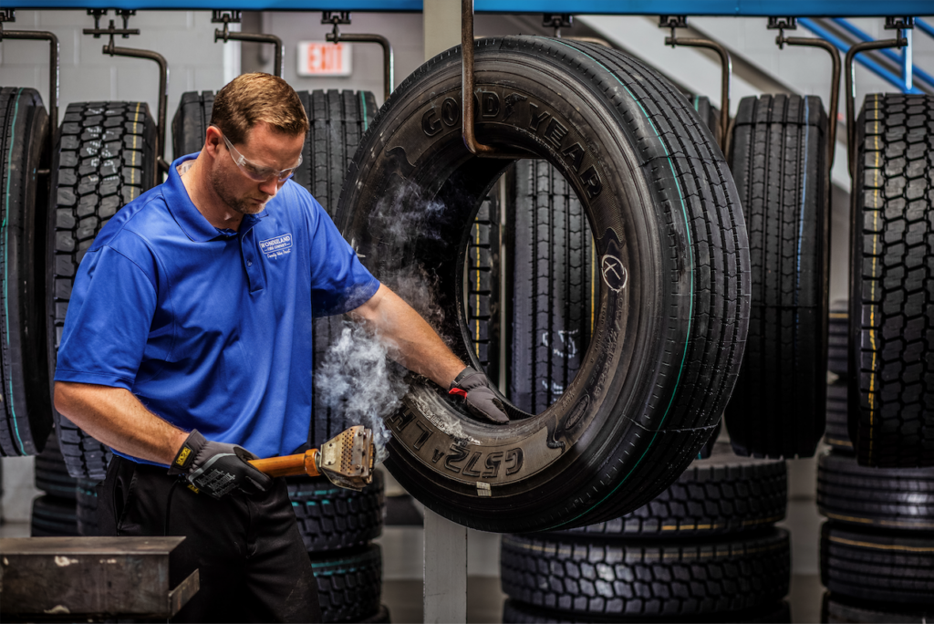 Man works on a retreaded tire