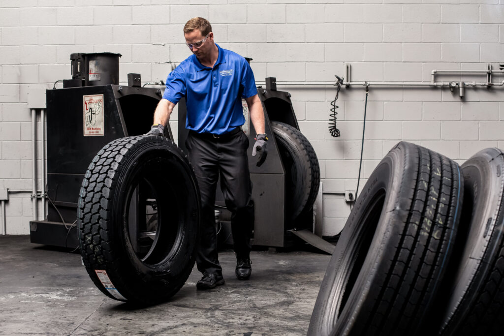 An AcuTread® technician rolls a newly remanufactured commercial tire.