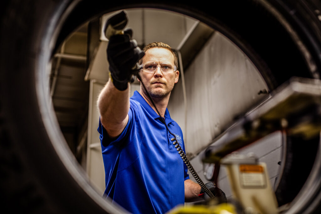 An AcuTread® tire technician scans the tracking bar code to facilitate easy reporting.