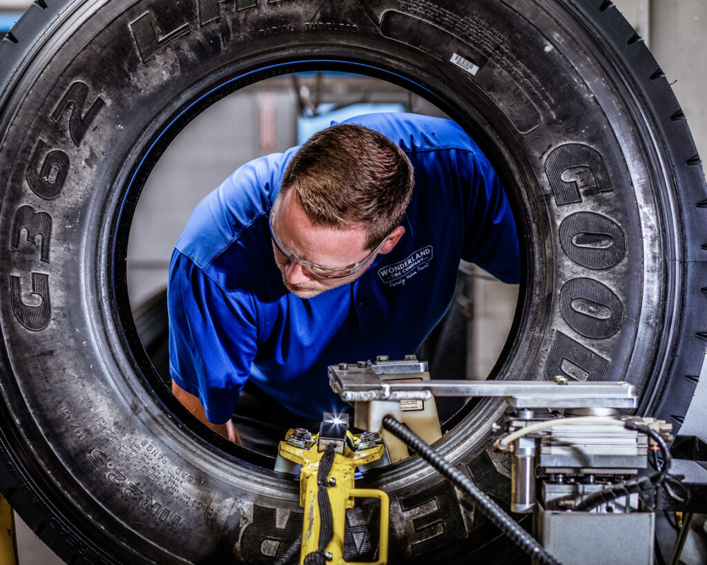 An AcuTread® technician inspects a newly remanufactured tire.